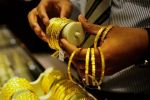 Gold prices slump to 10-month low, silver prices rise