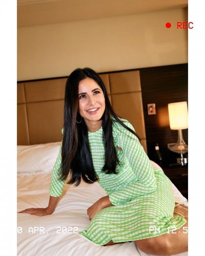 Katrina wreaks havoc in green and white check dress