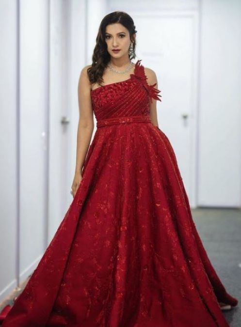 Gauhar Khan wears millions of one-shoulder red silk gowns