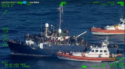 The coast guard saves more than 1,400 migrants from overcrowded boats off the coast of Italy