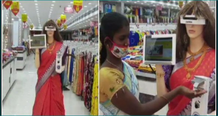This robot walks around wearing a sari in the shop, her work is praiseworthy
