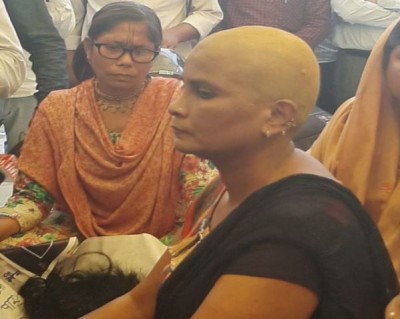 Woman protests by shaving in guest scholar movement, protest continues till 72nd day
