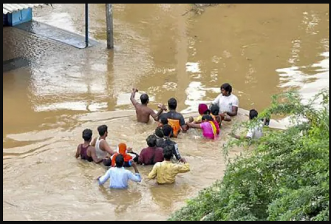 Video: Traffic cop braves raging floodwaters to save stranded priest in Andhra Pradesh