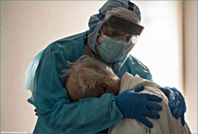 Photo of Doctor comforting elderly Covid-19 patient in Texas
