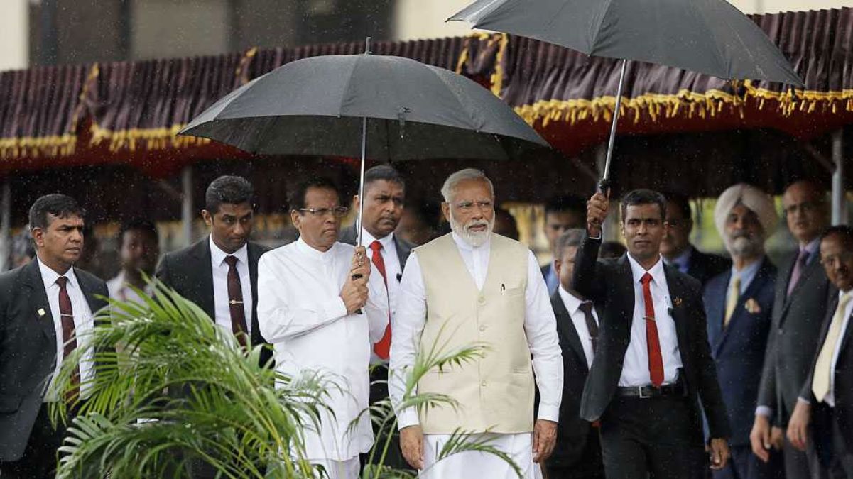 Sri Lanka president holds up umbrella for Modi during rains. See photo